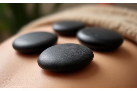 Close-up of hot stone massage on a person's back
